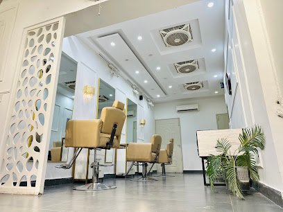 Inside Beauty Inn salon — styling chairs, mirrors and warm lighting